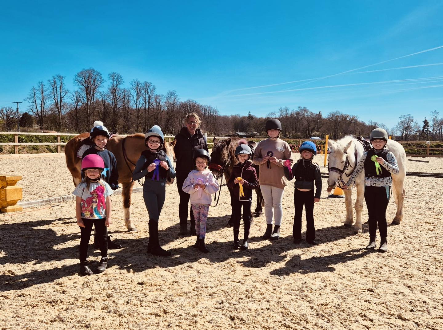 Childrens group riding lesson with rossettes